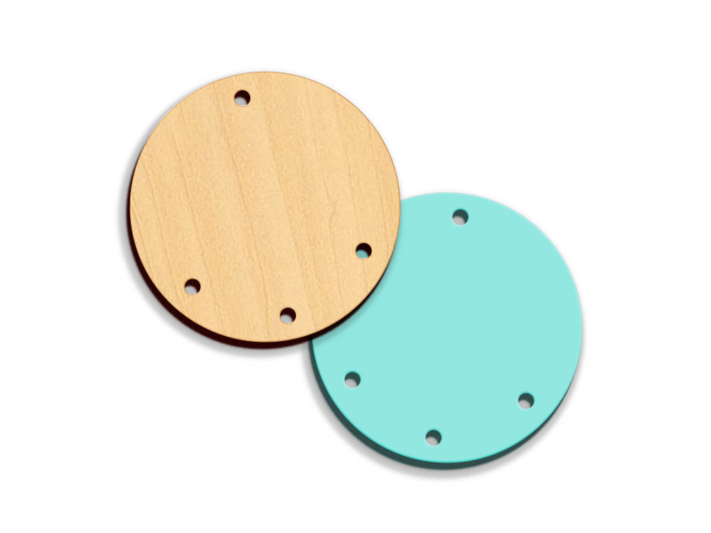 two wooden discs with holes in the middle