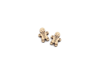 a pair of wooden cabochon stud earring blanks cut and engraved to look like a gingerbread man