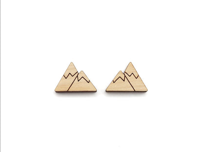 a pair of wooden cabochon stud earring blanks cut and engraved to look like snow-capped mountains