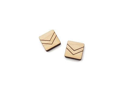 a pair of wooden cabochon stud earring blanks cut in a square shape and engraved with a chevron