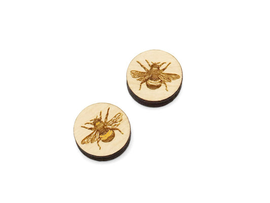 a pair of wooden bee studs on a white background