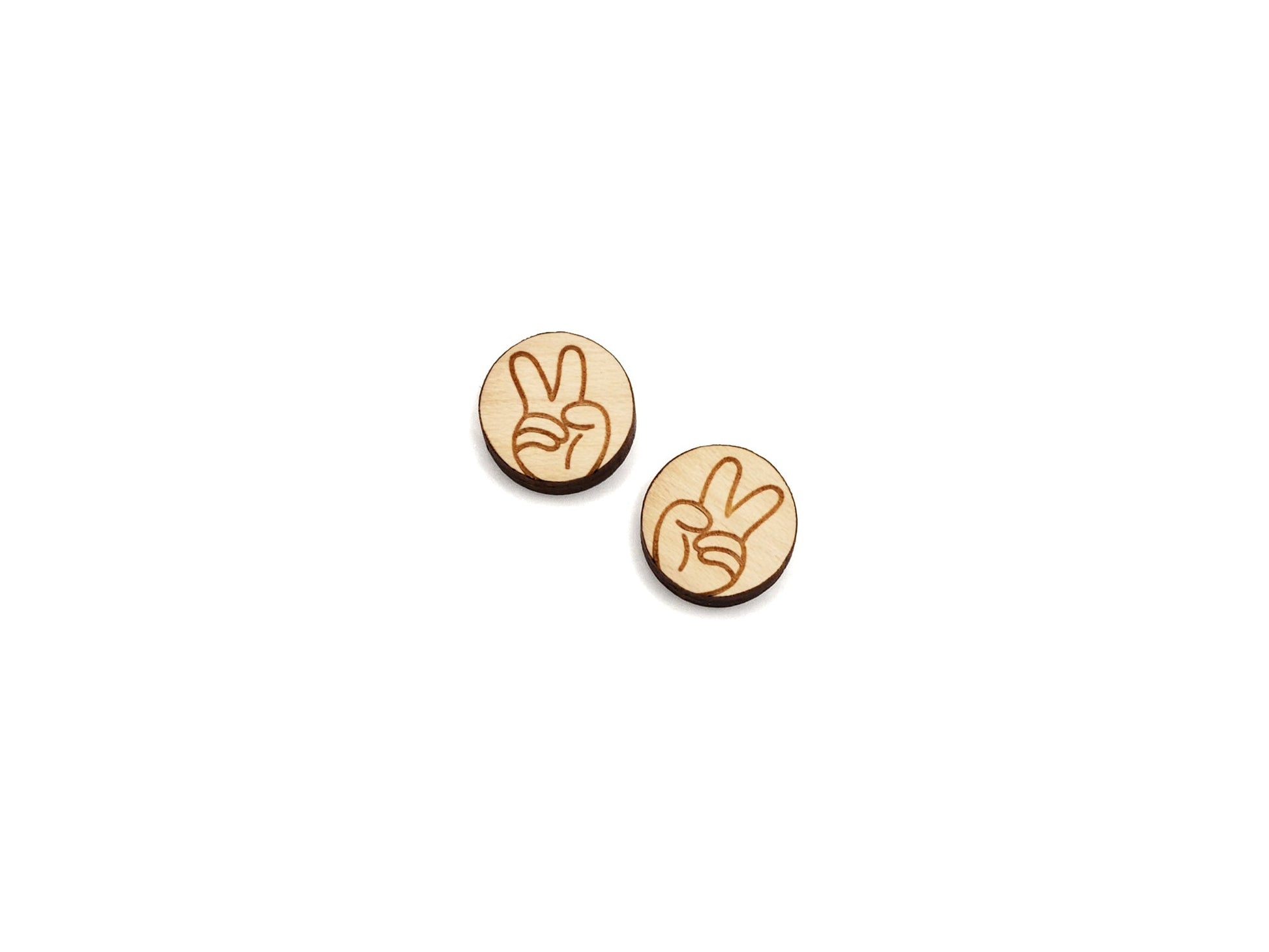 a pair of wooden buttons with a peace sign on them