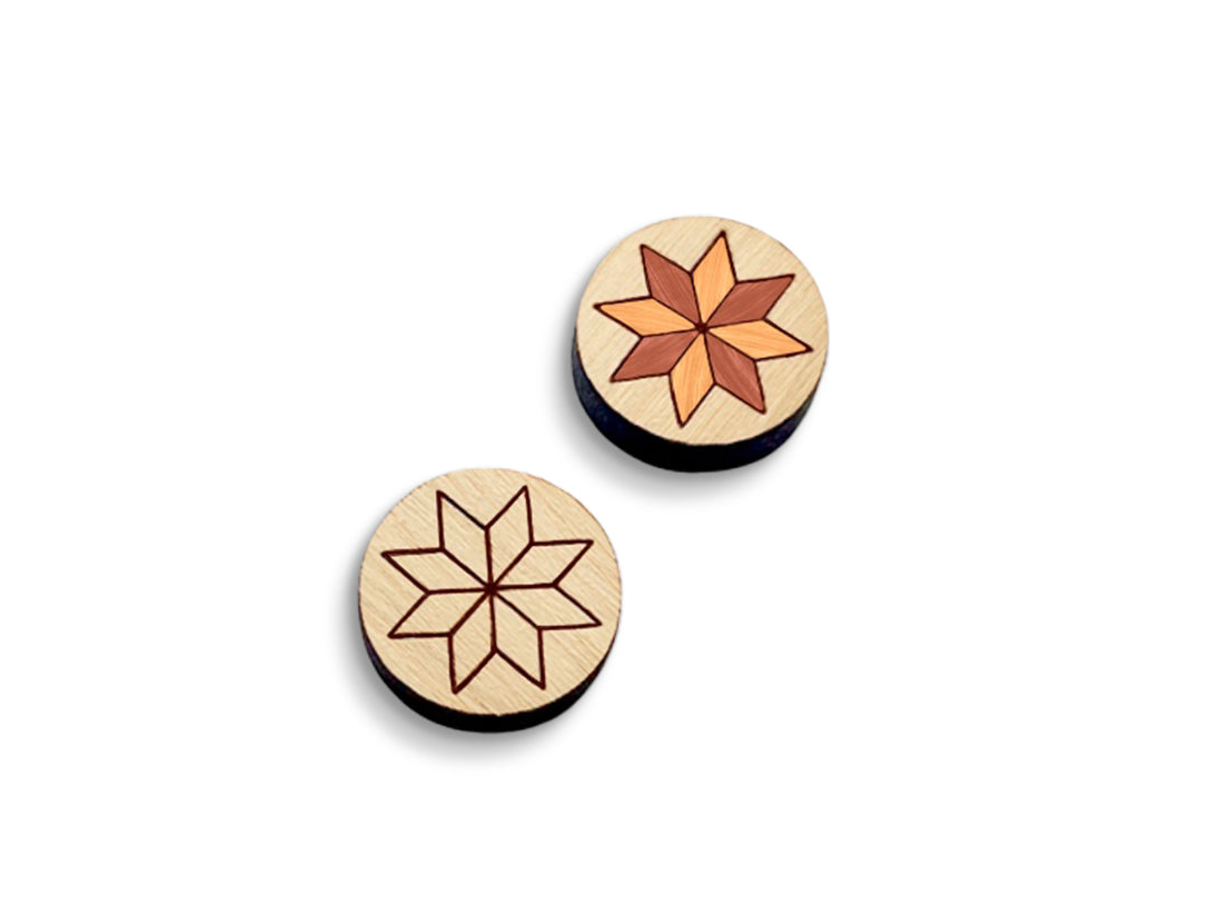 a pair of round wooden cabochon stud earring blanks engraved with a quilted star design