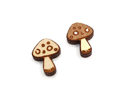 a pair of small wooden cabochon blanks for stud earrings, cut and engraved to look like mushrooms