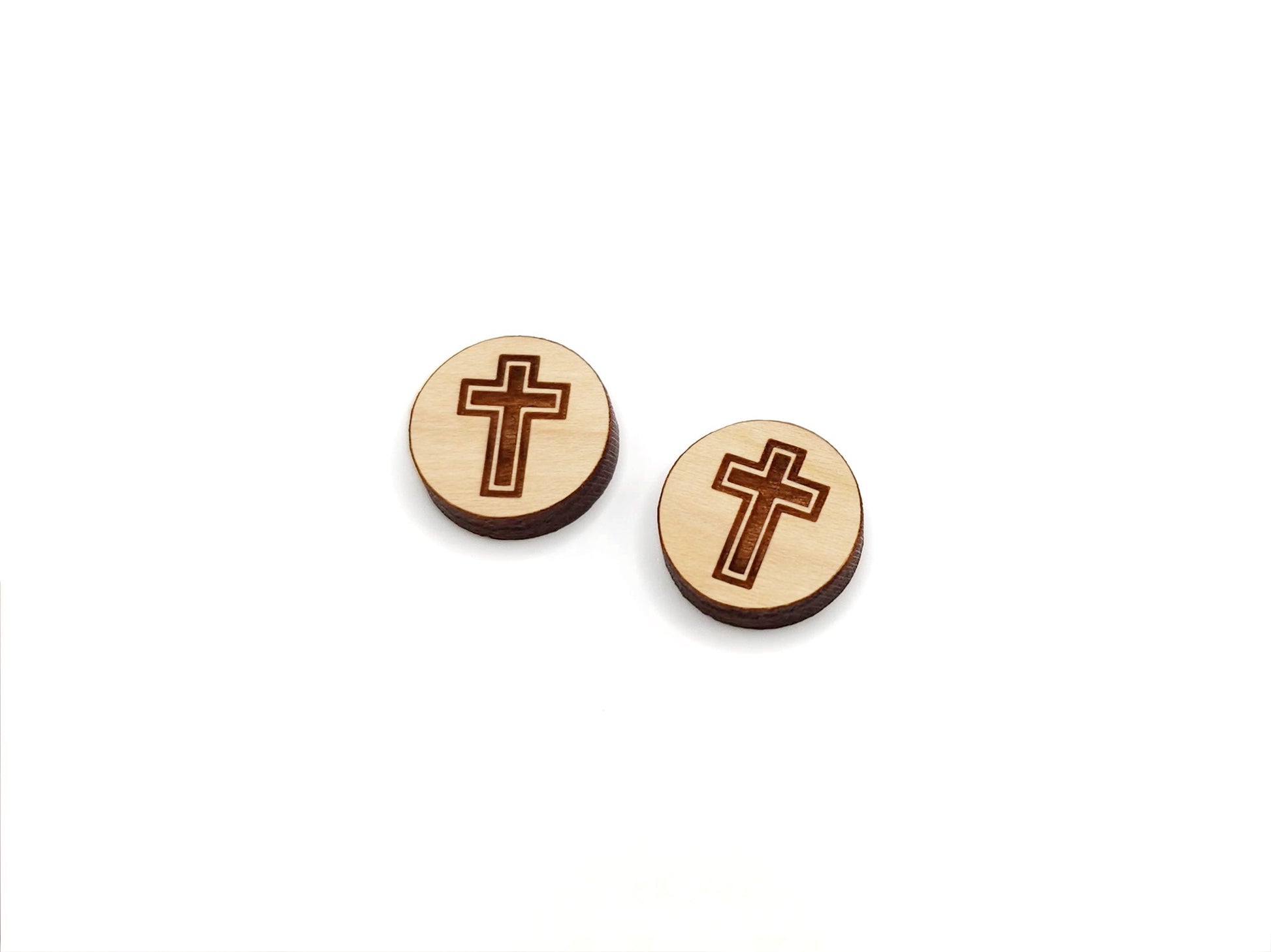 a pair of round wooden cabochon earring blanks engraved with a cross