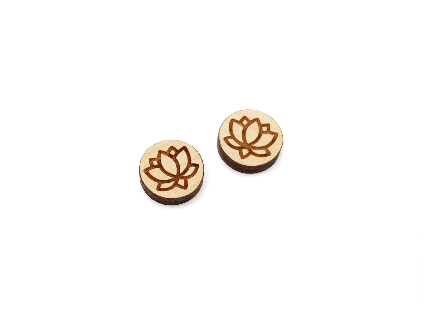 a pair of wooden earrings with a lotus design