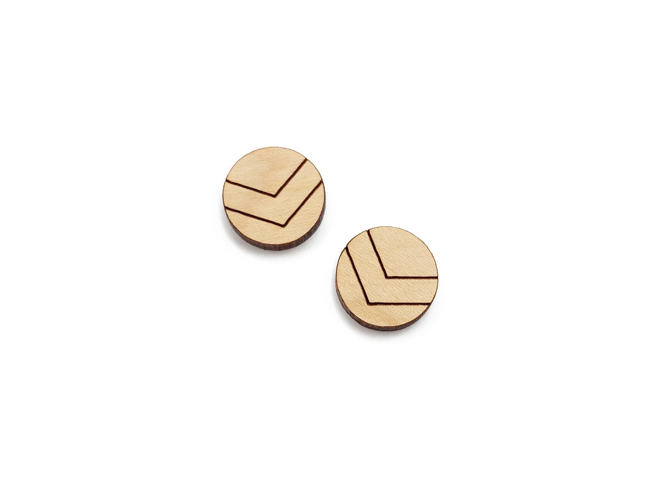 a pair of round wooden cabochon earring blanks engraved with chevron lines