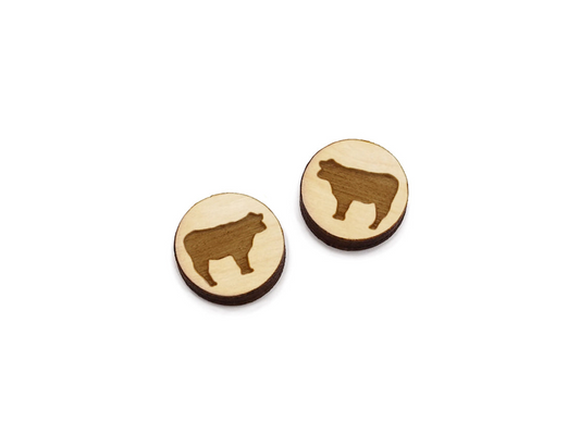 a pair of round wooden cabochon earring blanks engraved with a cow silhouette