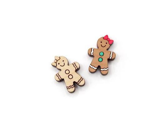 a pair of wooden cabochon stud earring blanks cut and engraved to look like a gingerbread girl