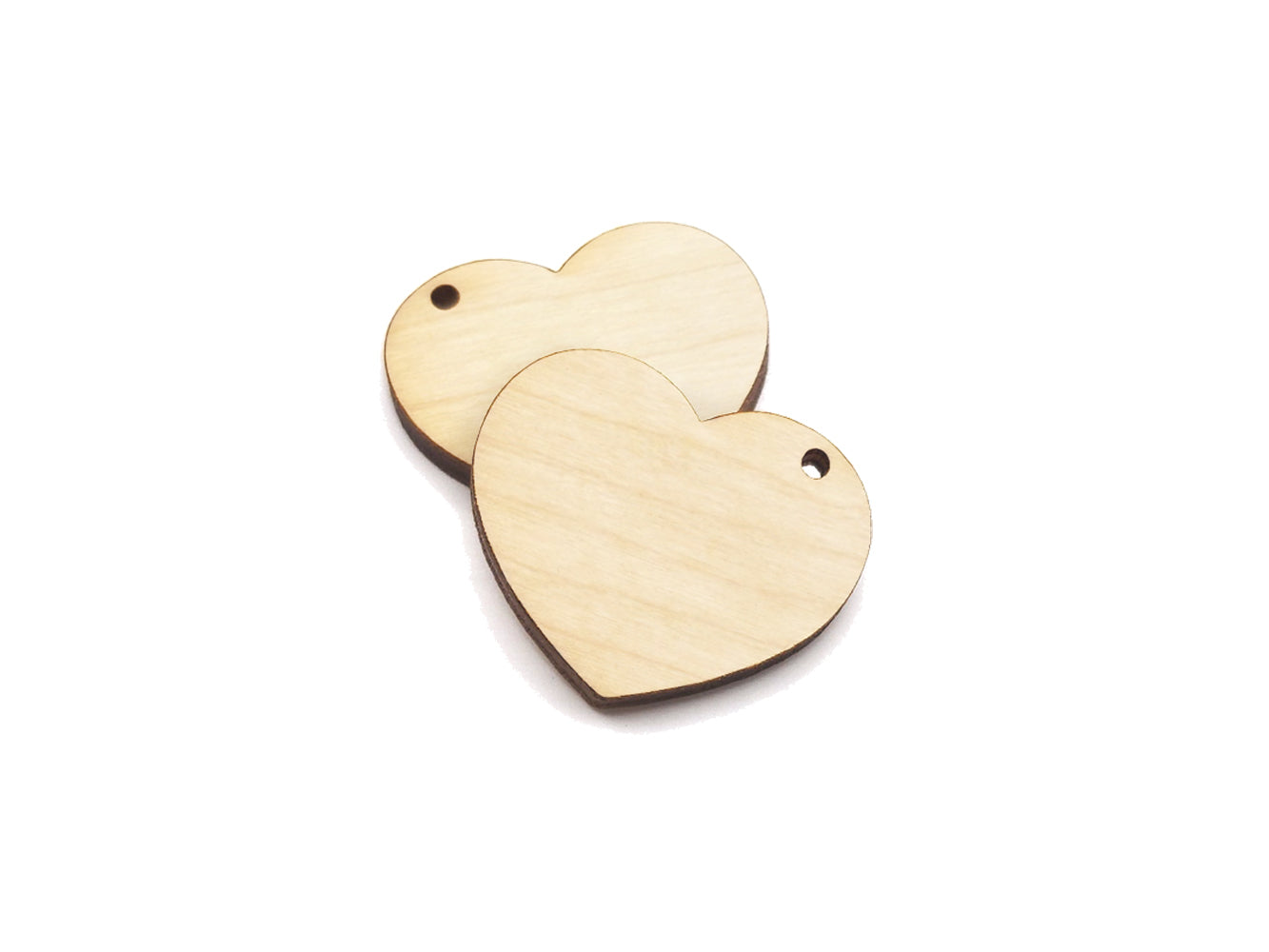 A pair of heart shaped wood or acrylic jewelry charm blanks