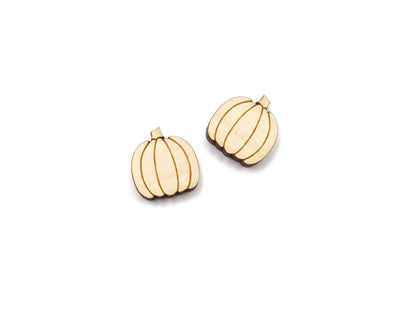 a pair of wooden cabochon stud earring blanks cut and engraved to look like pumpkins