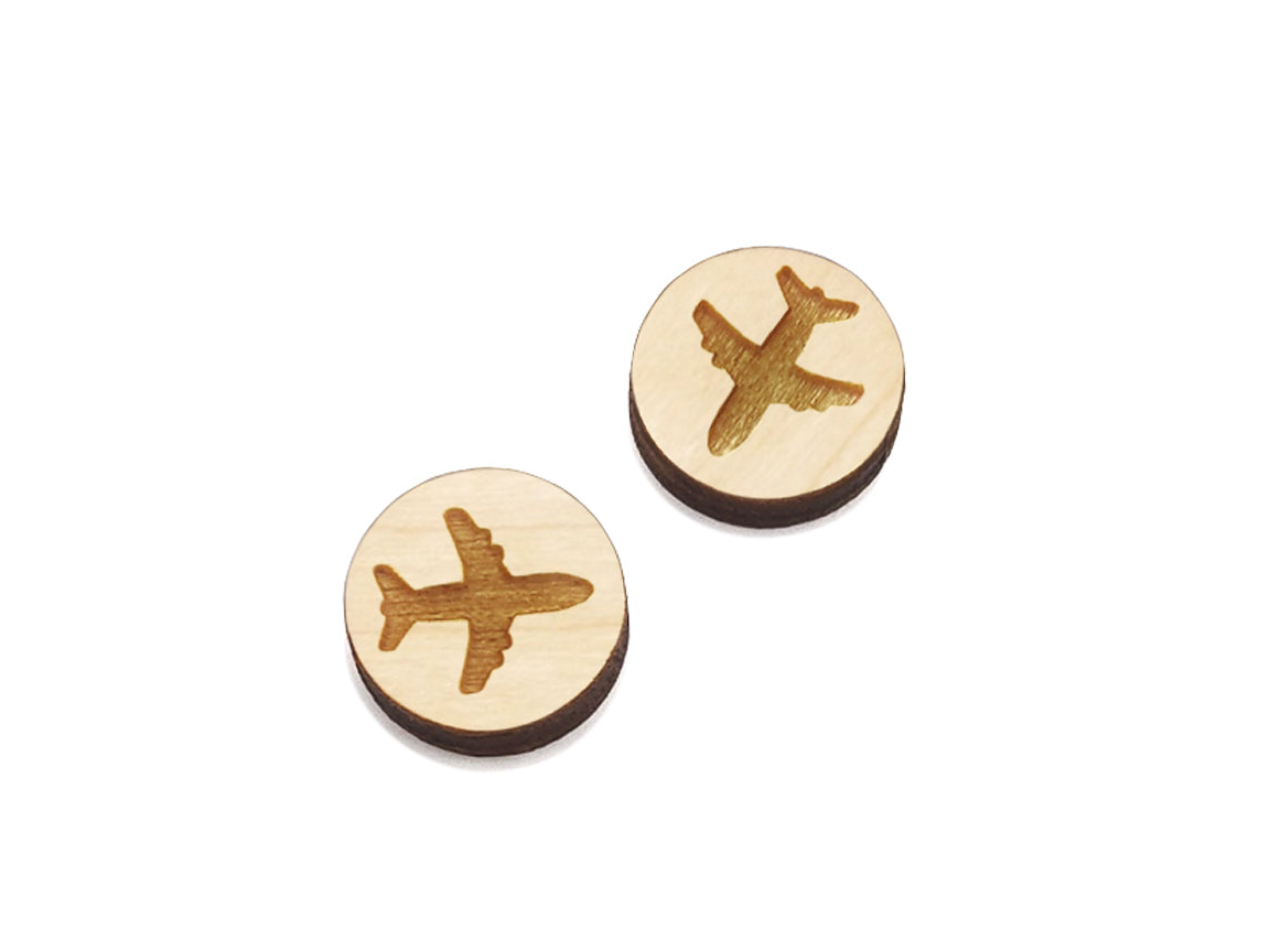 a pair of round wooden cabochon earring blanks engraved with a airplane silhouette