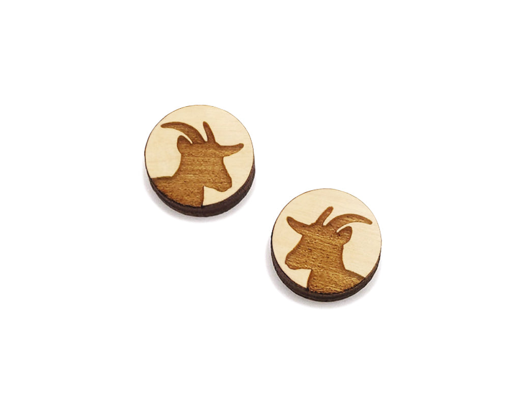 a pair of round wooden cabochon earring blanks engraved with a goat silhouette