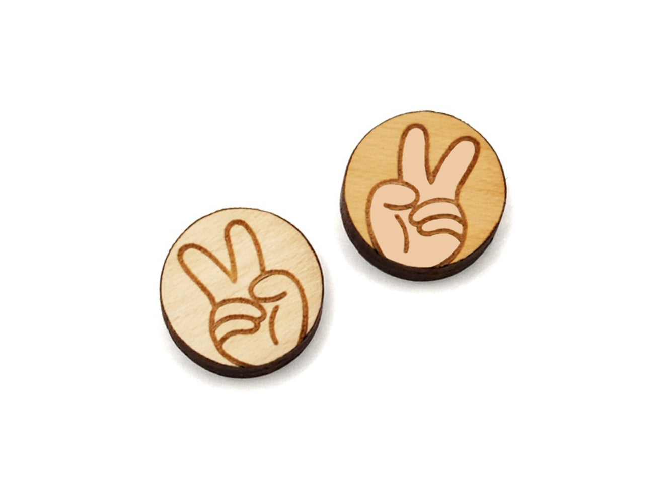 a pair of small round wooden cabochon blanks for stud earrings engraved with a hand making a peace sign.