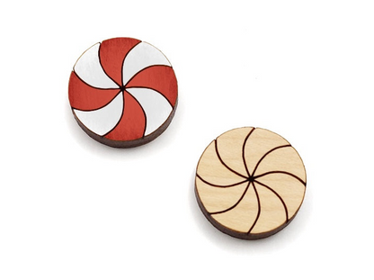 a pair of wooden cabochon stud earring blanks cut and engraved to look like peppermint candies