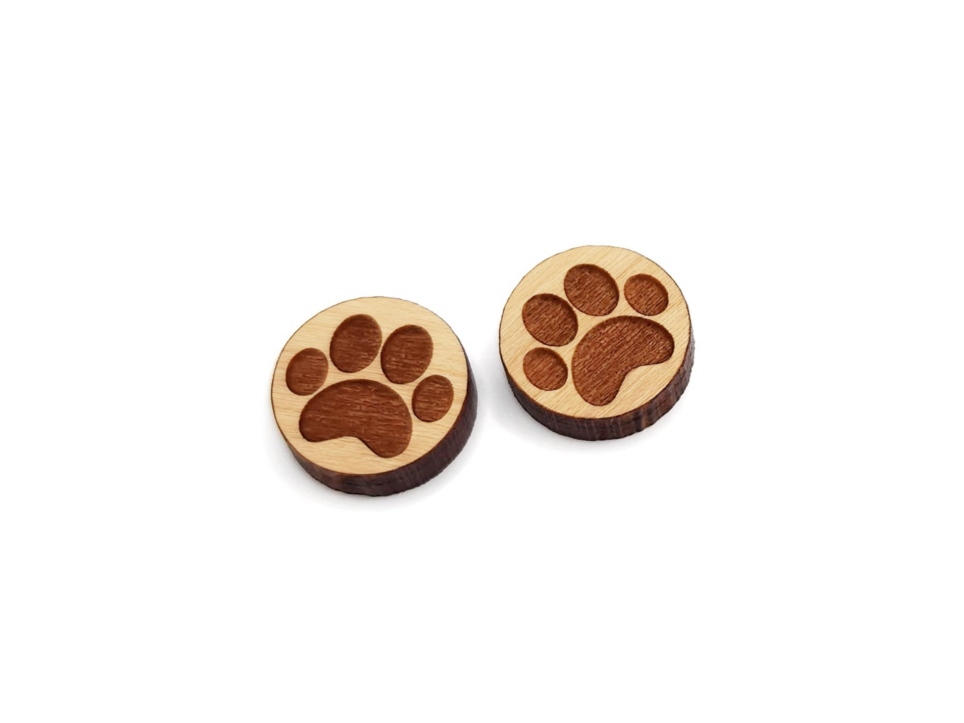 a pair of round wooden cabochon earring blanks engraved with a paw print