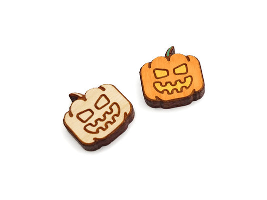 a pair of wooden cabochon earring blanks cut and engraved to look like a jack-O-lantern