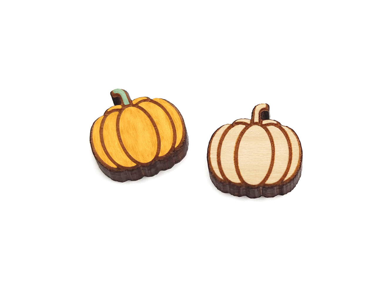 a pair of wooden cabochon earring blanks cut and engraved to look like a fall pumpkin