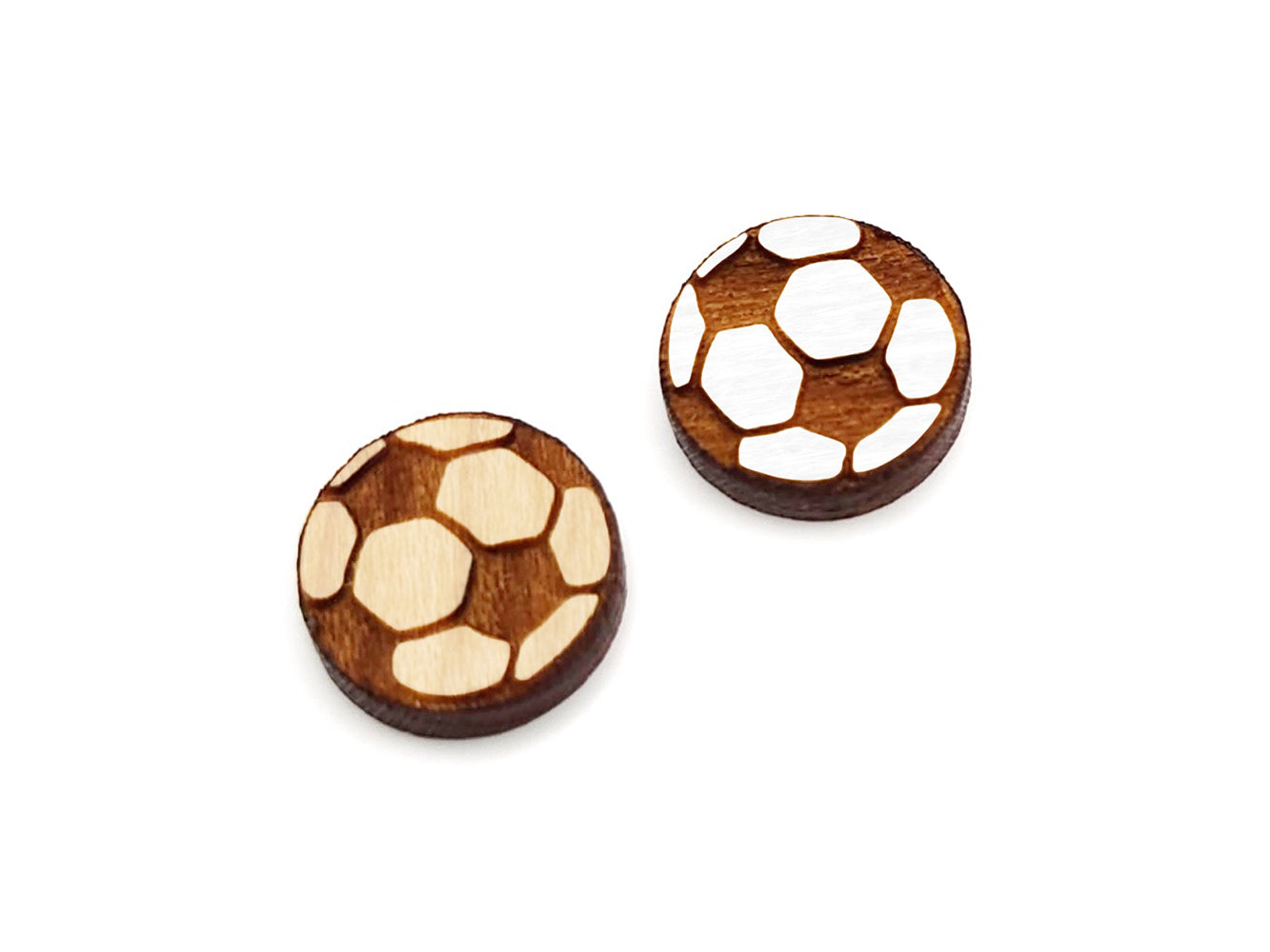 a pair of wooden cabochon earring blanks cut and engraved to look like a soccer ball