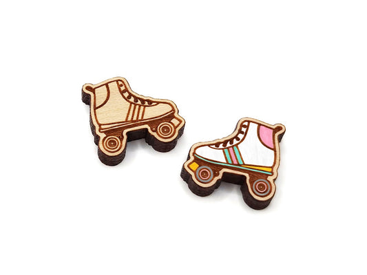 a pair of wooden cabochon earring blanks cut and engraved to look like a roller skate