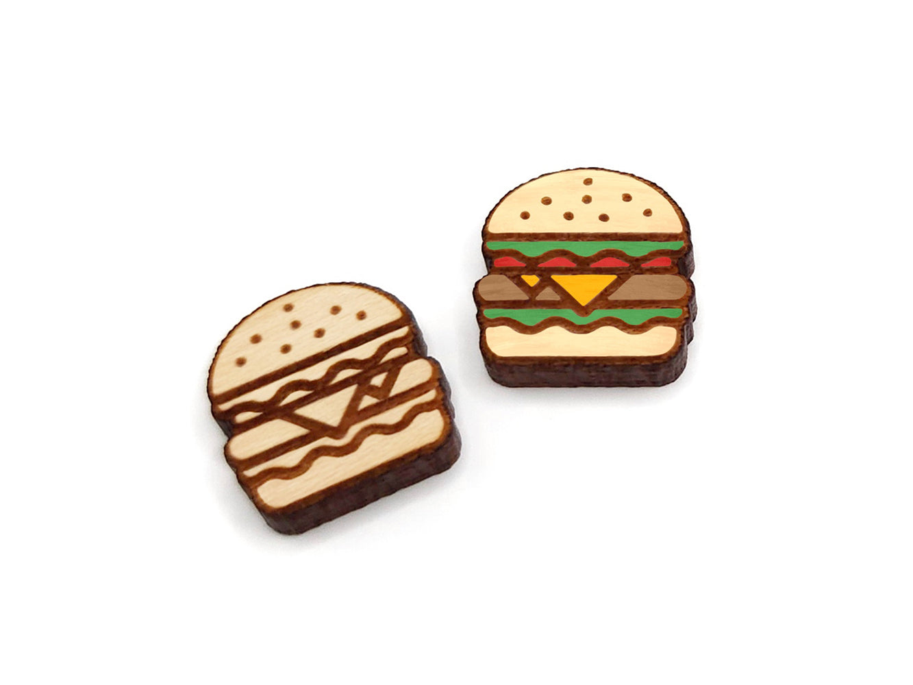 a pair of wooden cabochon stud earring blanks cut and engraved to look like a cheeseburger