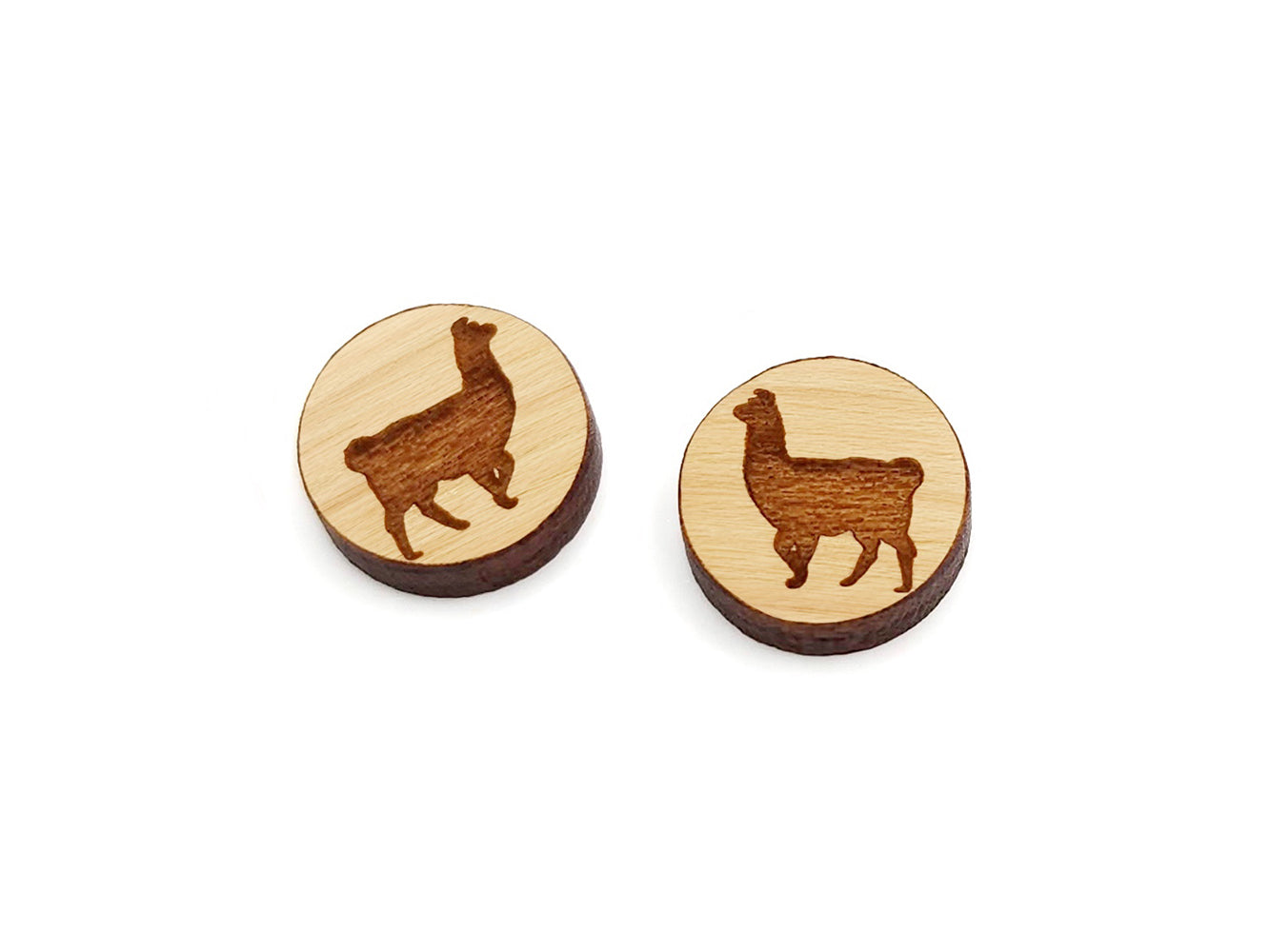 a pair of round wooden cabochon earring blanks engraved with a llama silhouette