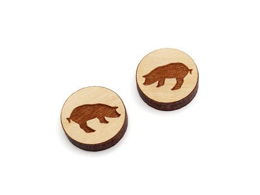 a pair of round wooden cabochon earring blanks engraved with a pig silhouette