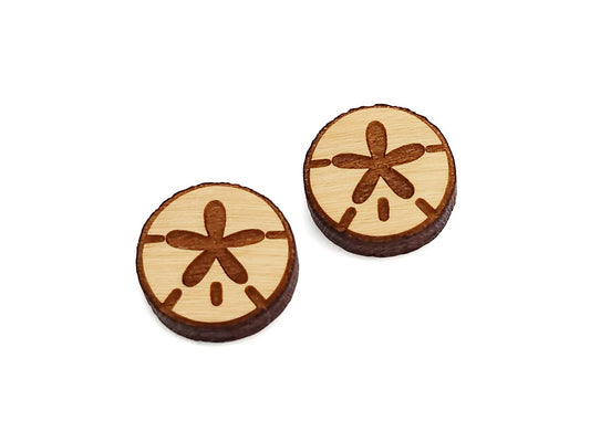 a pair of wooden cabochon stud earring blanks cut and engraved to look like a sand dollar