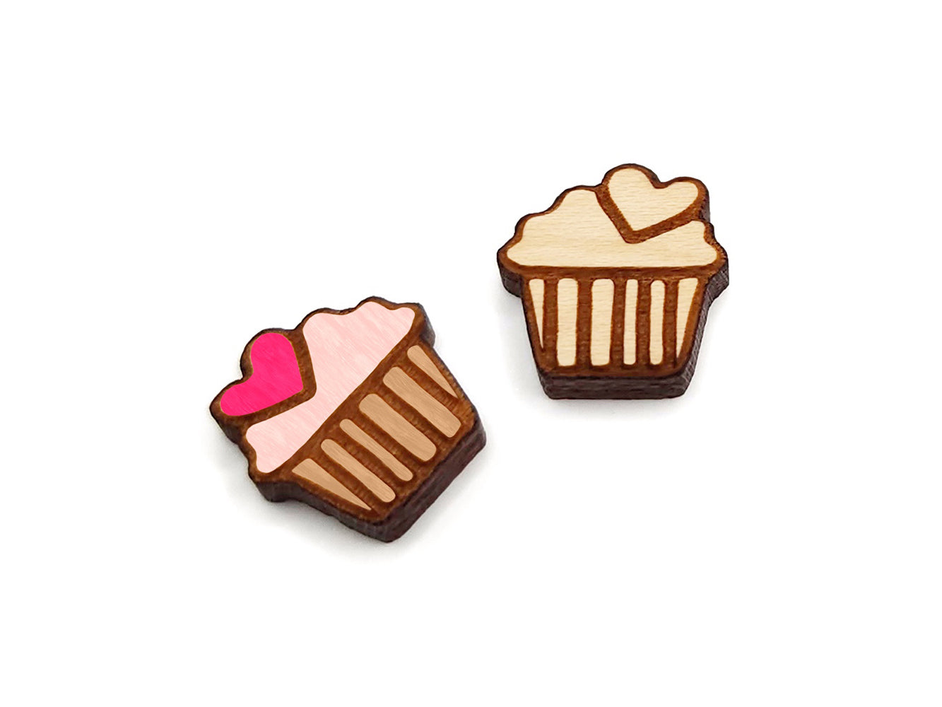 a pair of wooden cabochon stud earring blanks cut and engraved to look like a cupcake