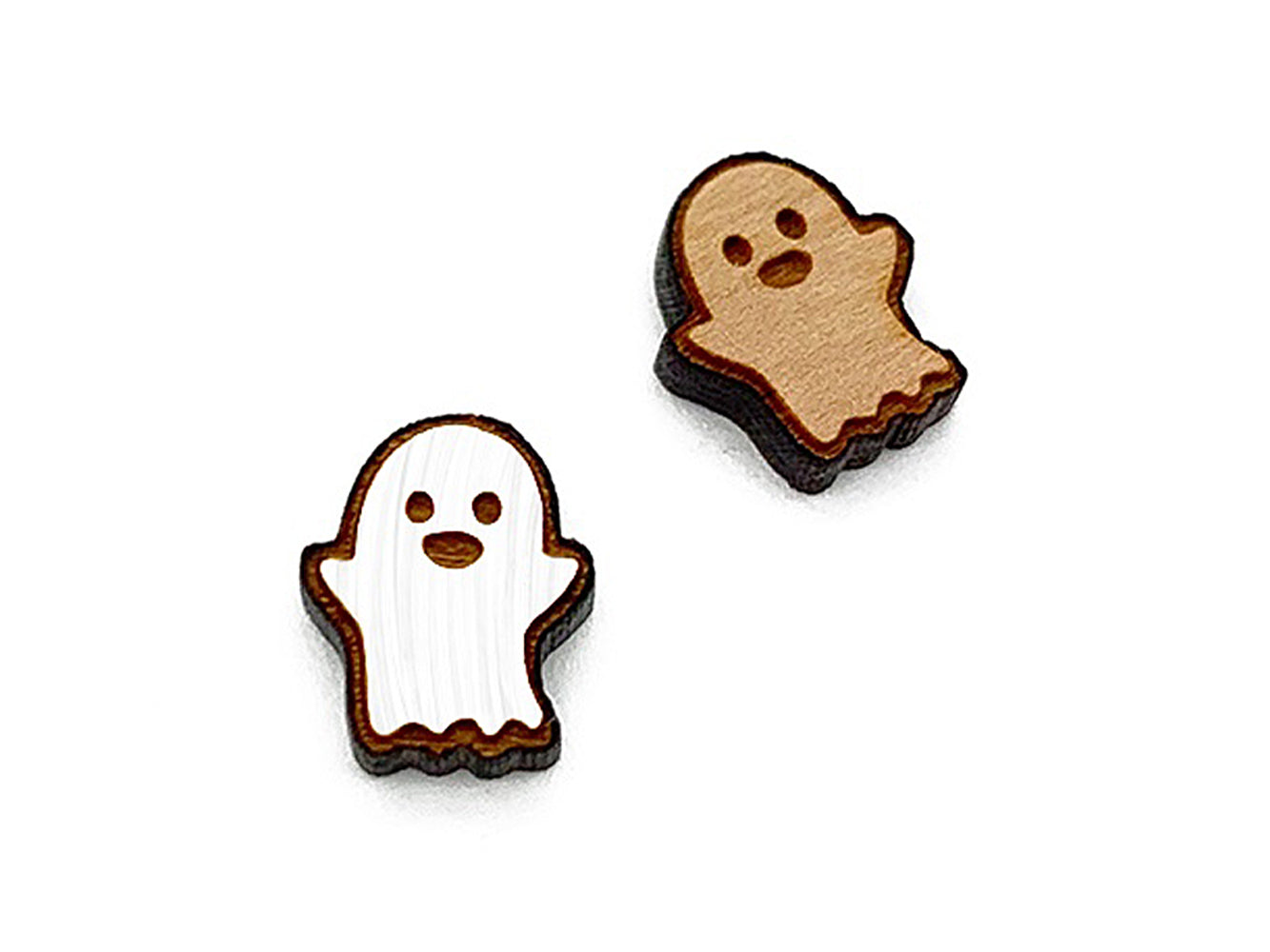 a pair of wooden cabochon stud earring blanks cut and engraved to look like a ghost