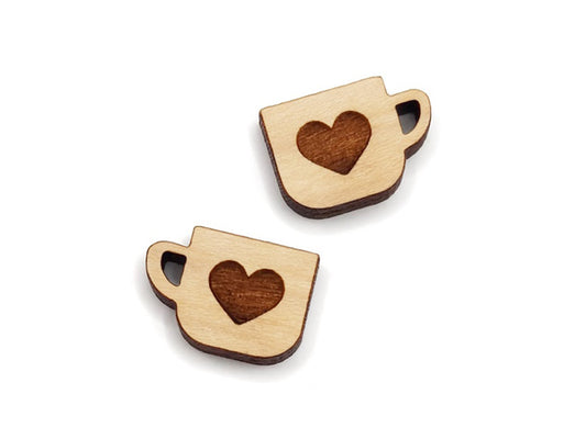 a pair of wooden cabochon stud earring blanks cut and engraved to look like a mug with a heart