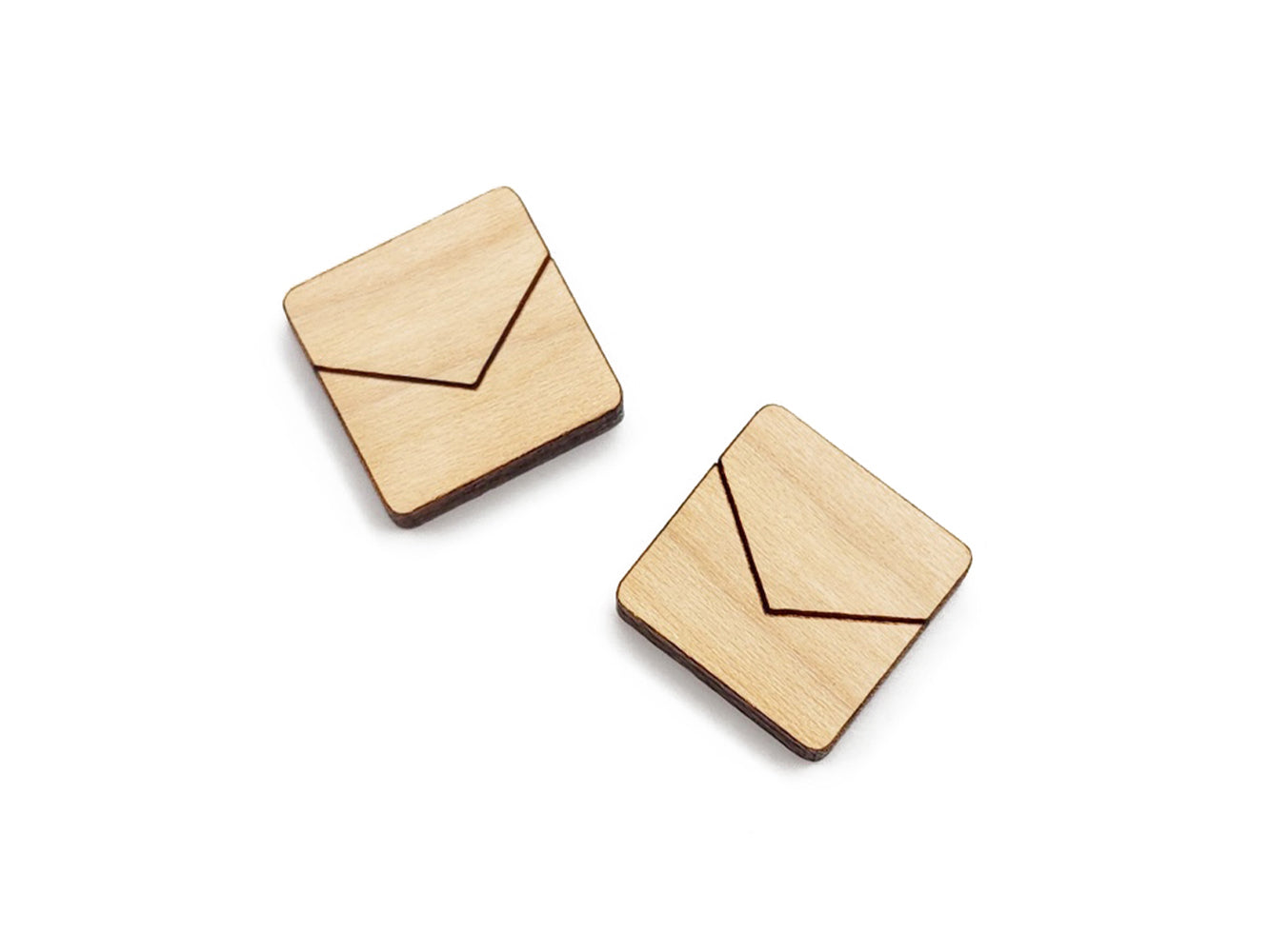 a pair of wooden cabochon stud earring blanks cut in a square shape and engraved with a chevron line