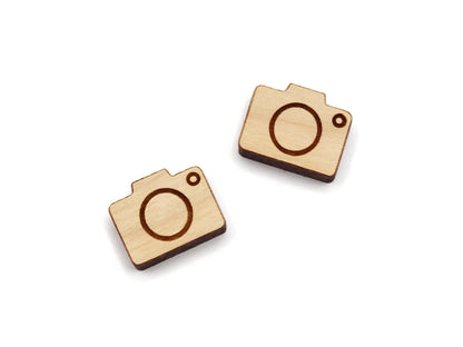 a pair of wooden cabochon stud earring blanks cut and engraved to look like a camera