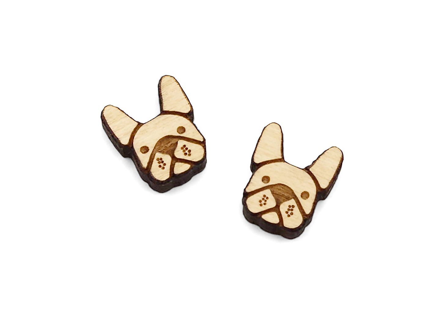 a pair of small wooden cabochon blanks for stud earrings, cut and engraved to look like french bulldogs