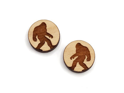 a pair of round wooden cabochon earring blanks engraved with a Bigfoot