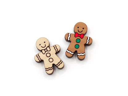 a pair of wooden cabochon stud earring blanks cut and engraved to look like a gingerbread man