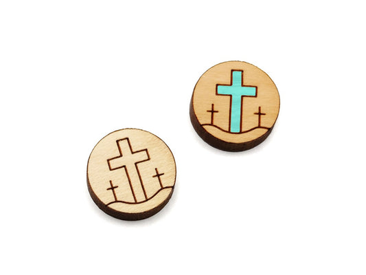 a pair of small round wooden cabochon blanks for stud earrings engraved with three crosses