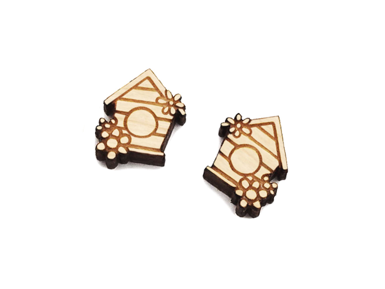 a pair of wooden cabochon stud earring blanks cut and engraved to look like a birdhouse with flowers