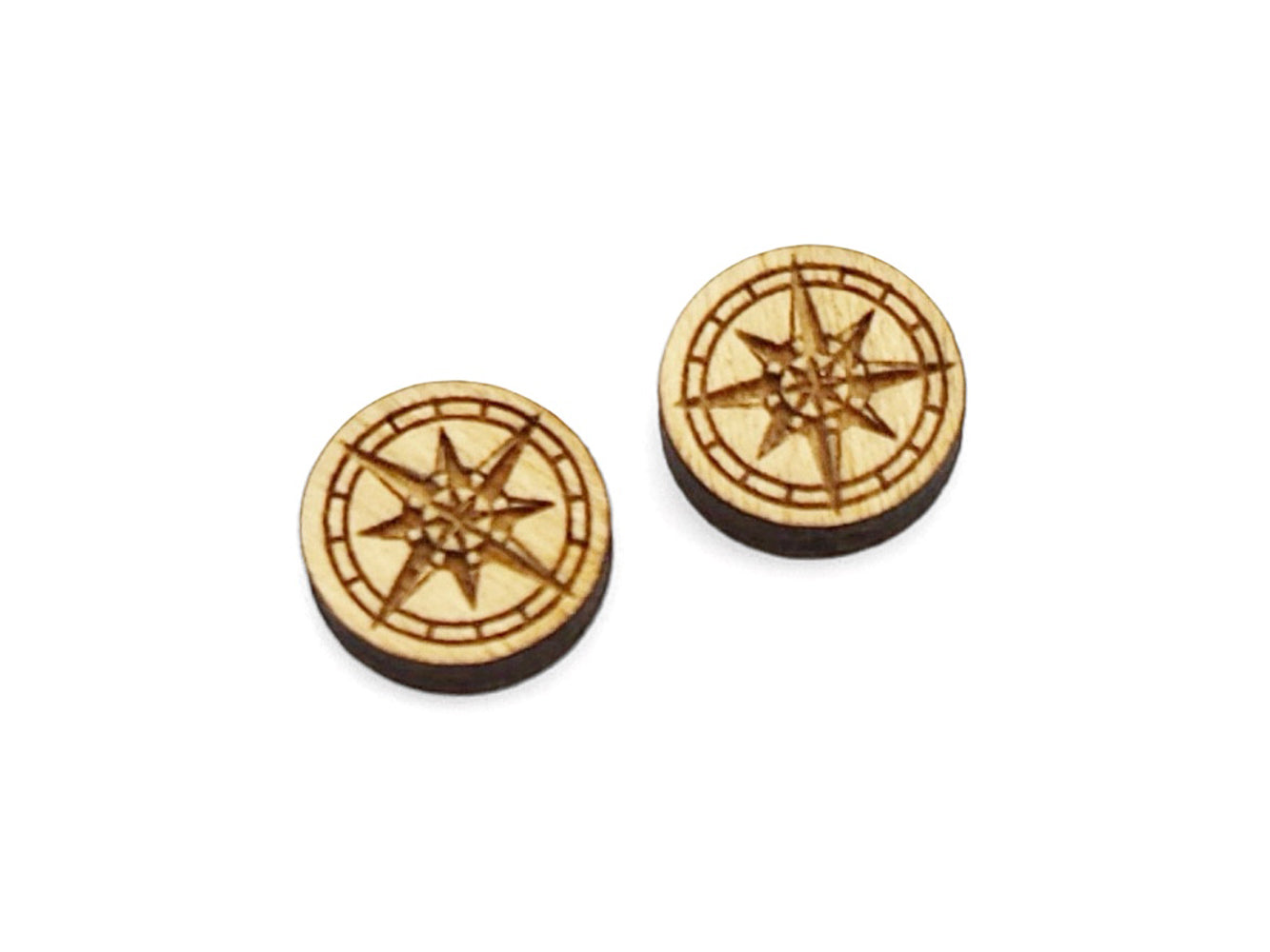 a pair of small round wooden cabochon blanks for stud earrings engraved with a compass