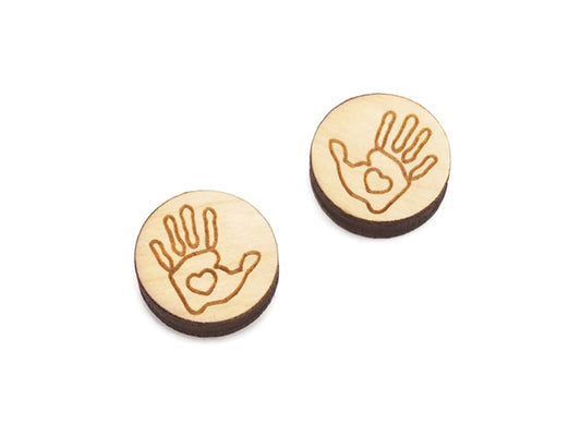 a pair of round wooden cabochon earring blanks engraved with a handprint outline with a heart