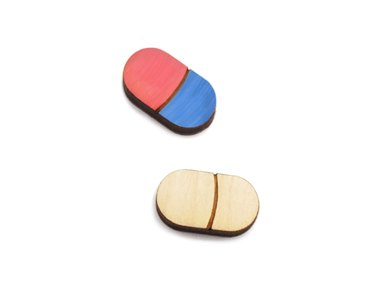 a pair of small wooden cabochon blanks for stud earrings, cut and engraved to look like a medicine capsule