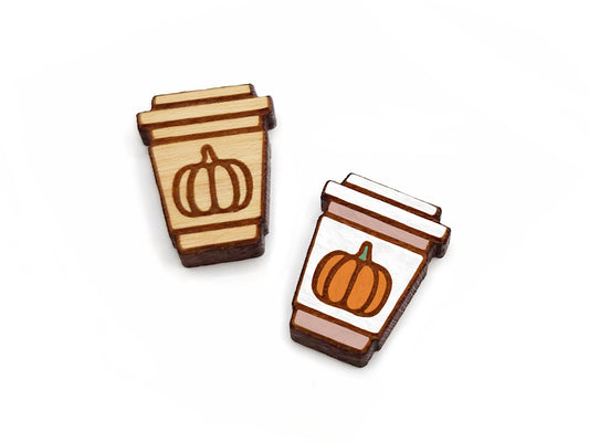 a pair of wooden cabochon stud earring blanks cut and engraved to look like a latte with a pumpkin