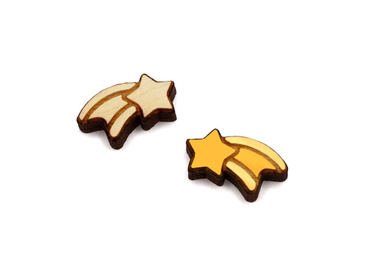 a pair of wooden cabochon stud earring blanks cut and engraved to look like a shooting star