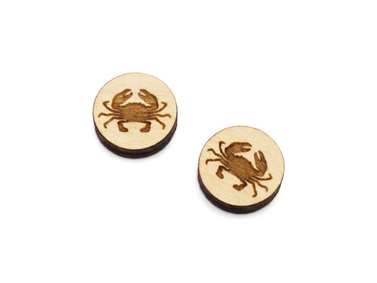 a pair of small round wooden cabochon blanks for stud earrings engraved with a crab