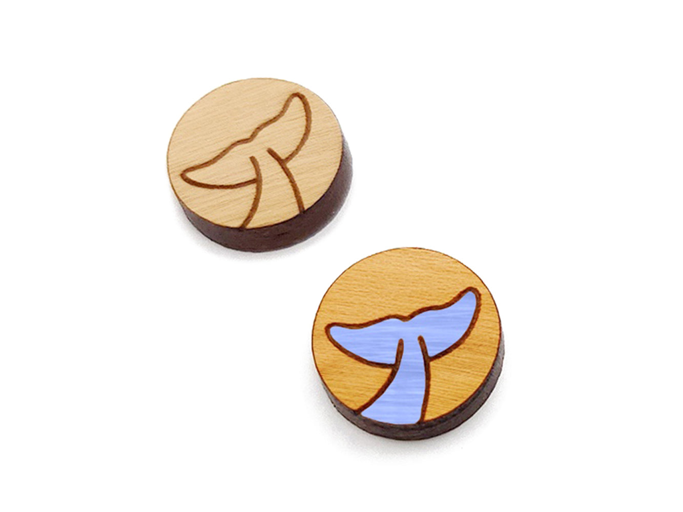 a pair of round wooden cabochon earring blanks engraved with a whale's tail