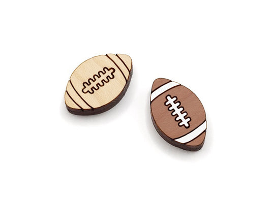 a pair of wooden cabochon stud earring blanks cut and engraved to look like footballs