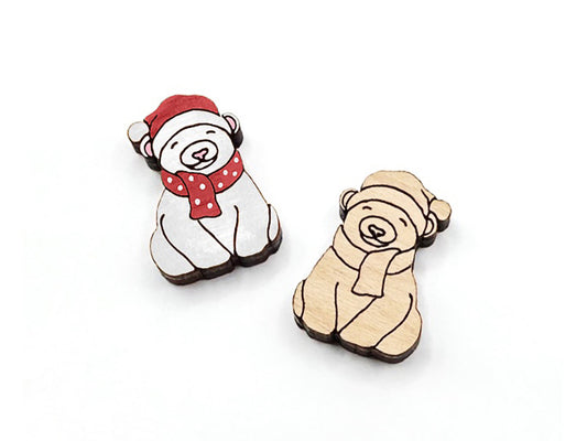 a pair of small wooden cabochon blanks for stud earrings, cut and engraved to look like a polar bear wearing a scarf, one is painted