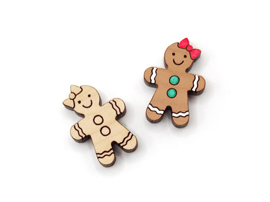 a pair of wooden cabochon stud earring blanks cut and engraved to look like a gingerbread girl