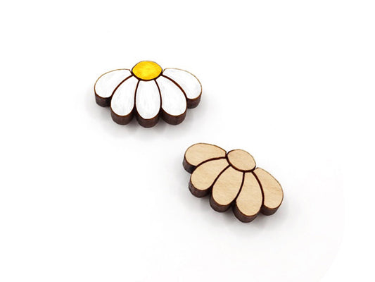 a pair of wooden cabochon stud earring blanks cut and engraved to look like daisy flowers