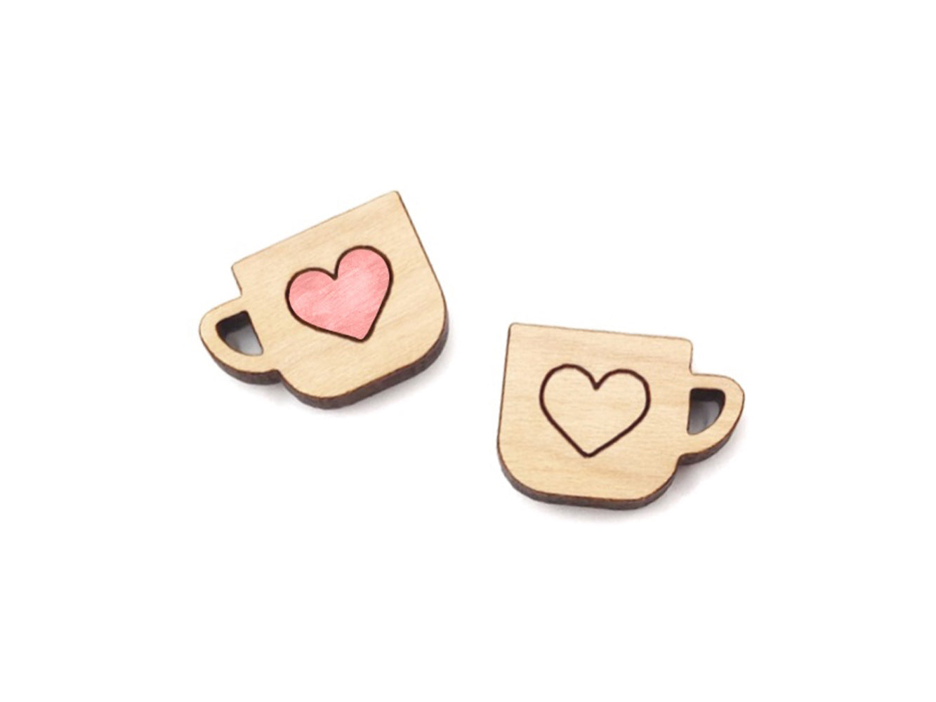 a pair of wooden cabochon stud earring blanks cut and engraved to look like mugs with a heart outline